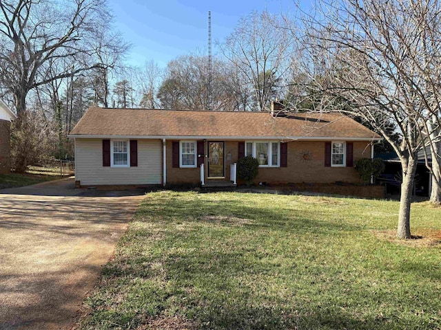 single story home with concrete driveway and a front lawn