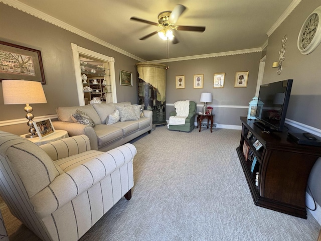 living area with built in shelves, carpet, crown molding, a ceiling fan, and baseboards