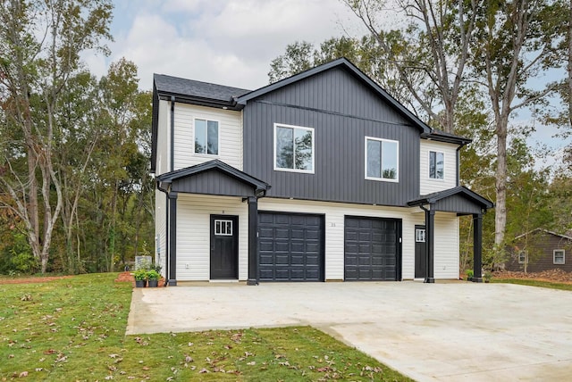 view of front facade featuring an attached garage, a front lawn, and concrete driveway