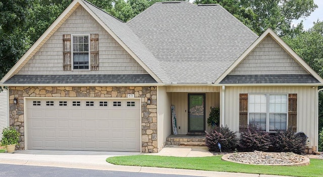 view of front of property featuring driveway, stone siding, a shingled roof, and board and batten siding