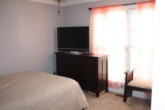 bedroom featuring light colored carpet and crown molding