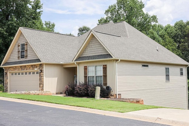 view of front of property featuring a garage, stone siding, and a shingled roof