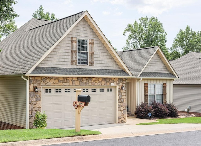 view of front of house with a garage, concrete driveway, stone siding, roof with shingles, and board and batten siding