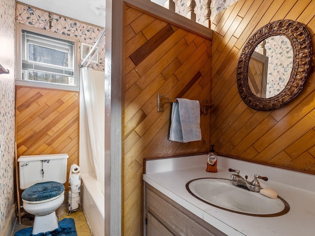 full bath featuring shower / tub combo with curtain, wooden walls, toilet, and vanity