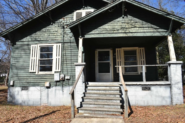 bungalow-style home featuring covered porch and crawl space