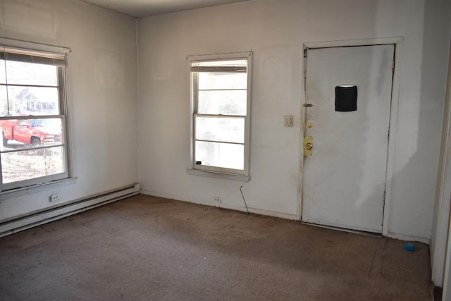 carpeted spare room with a healthy amount of sunlight and a baseboard radiator