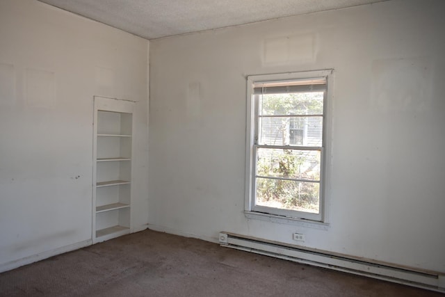 spare room featuring a textured ceiling, baseboard heating, and carpet flooring