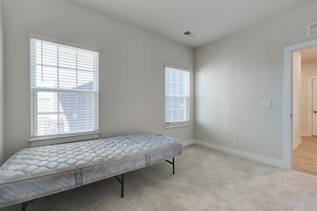 bedroom with baseboards, visible vents, and carpet flooring