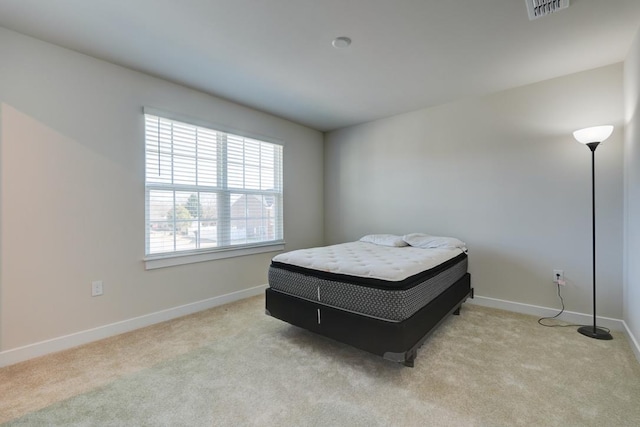 bedroom with carpet floors, visible vents, and baseboards