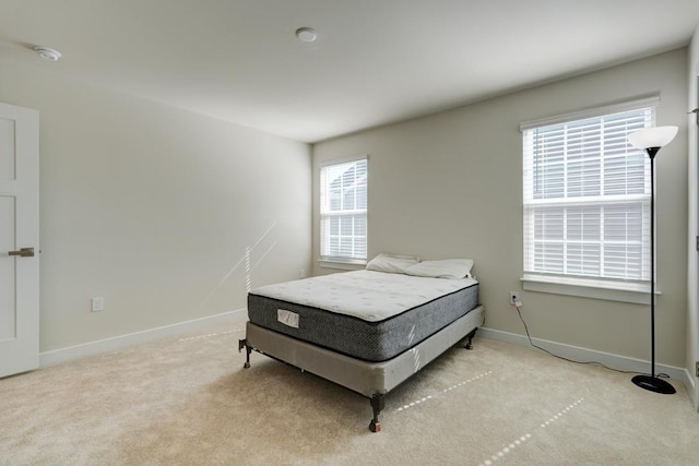 bedroom featuring carpet and baseboards