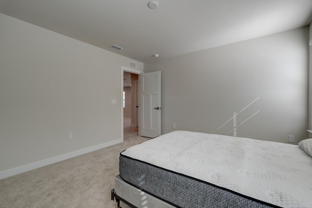 bedroom featuring baseboards, visible vents, and light colored carpet