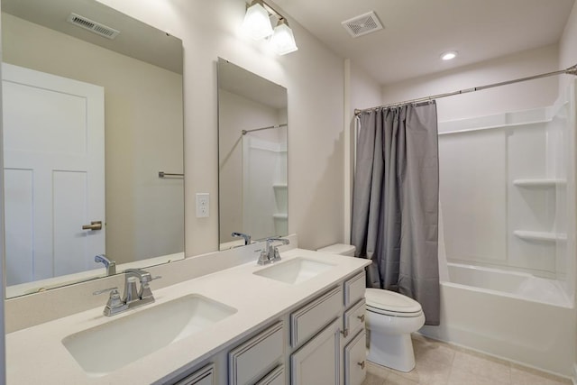 bathroom featuring toilet, a sink, and visible vents