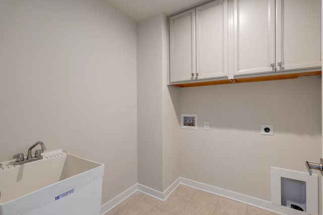 washroom featuring cabinet space, baseboards, hookup for an electric dryer, washer hookup, and a sink