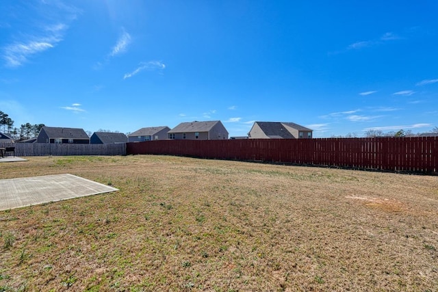 view of yard featuring a patio area and a fenced backyard