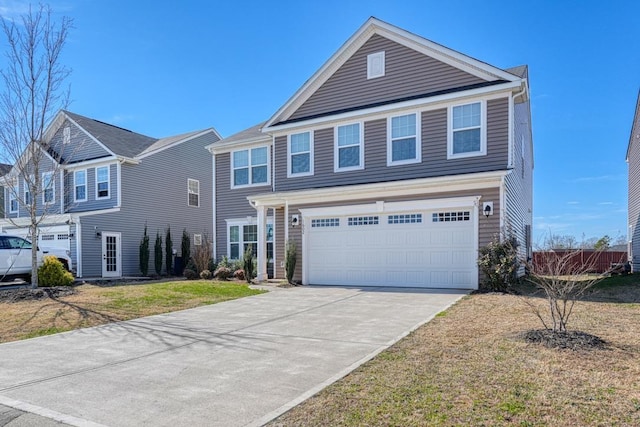 view of front of home featuring driveway, an attached garage, and a front yard