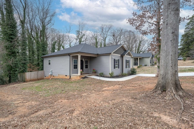 ranch-style house with crawl space, a shingled roof, and fence