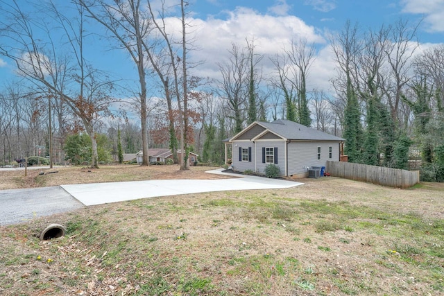 view of yard with fence and driveway