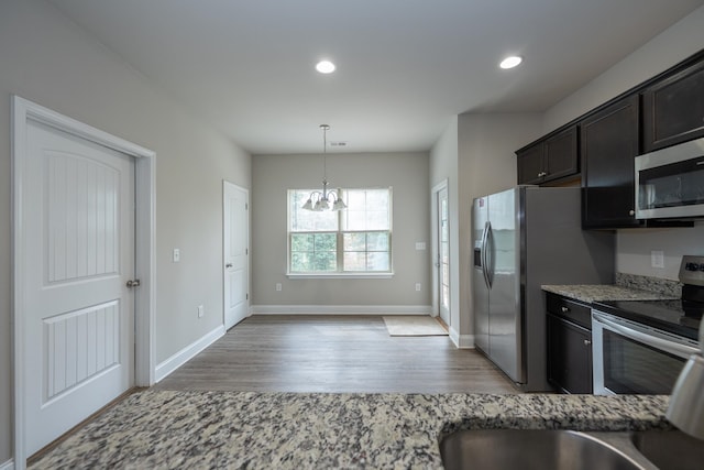 kitchen featuring baseboards, stainless steel appliances, light wood-type flooring, and recessed lighting