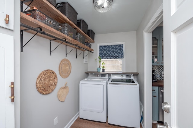 washroom featuring washer and dryer, laundry area, and baseboards