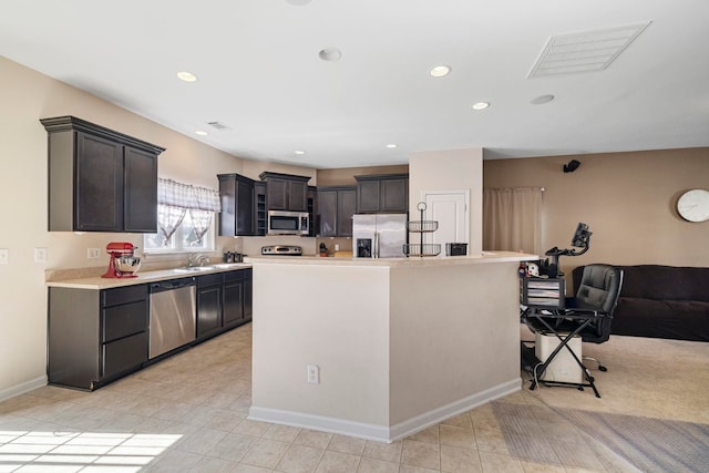 kitchen with stainless steel appliances, recessed lighting, light countertops, visible vents, and baseboards