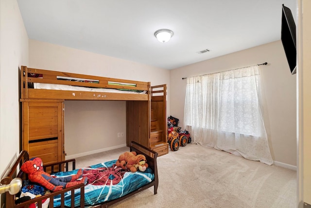 carpeted bedroom featuring visible vents and baseboards