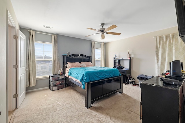 bedroom featuring ceiling fan, visible vents, baseboards, and light colored carpet