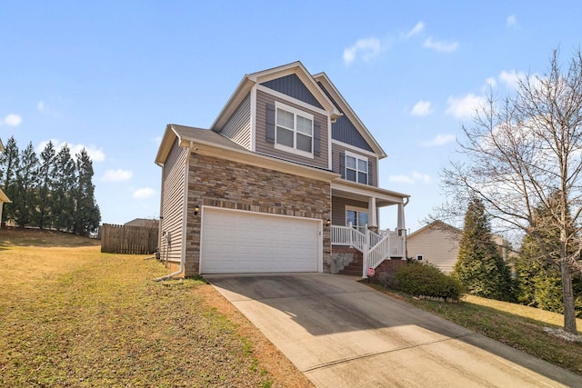 view of front of house with driveway, stone siding, an attached garage, covered porch, and a front lawn