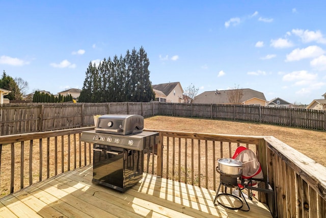 wooden terrace featuring a fenced backyard and grilling area