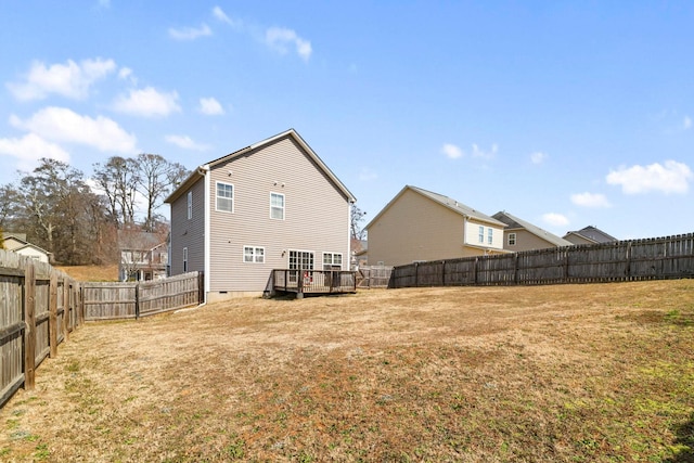 back of house featuring crawl space, a lawn, and a fenced backyard