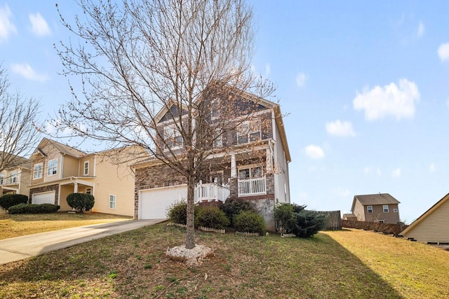 traditional-style house featuring concrete driveway and a front lawn