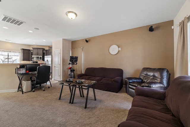 living room featuring light carpet, baseboards, visible vents, and recessed lighting