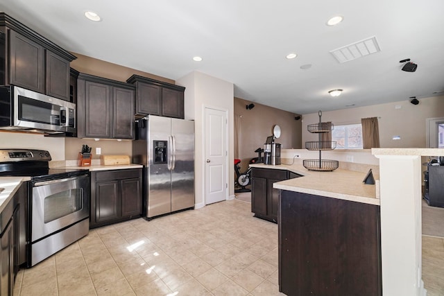 kitchen with stainless steel appliances, recessed lighting, light countertops, visible vents, and dark brown cabinetry