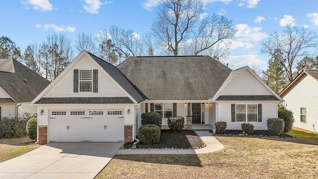 view of front facade with roof with shingles, covered porch, concrete driveway, a garage, and a front lawn