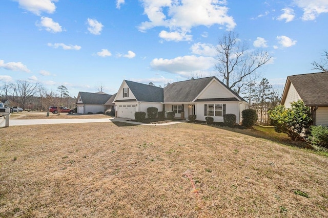 view of front of house with an attached garage and a front yard