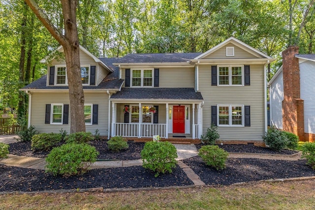 traditional home with crawl space, covered porch, and a shingled roof