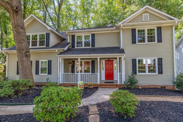 traditional-style house with crawl space, covered porch, and roof with shingles