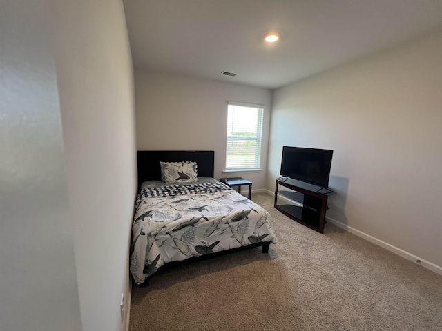 bedroom with visible vents, baseboards, and carpet