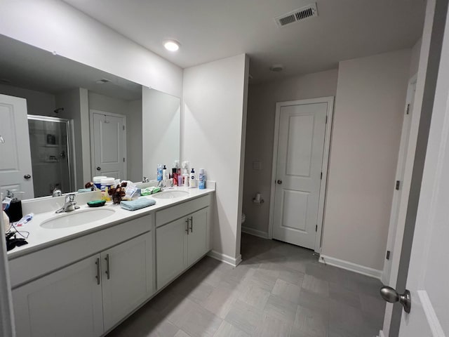 full bath featuring a sink, visible vents, toilet, and a shower stall