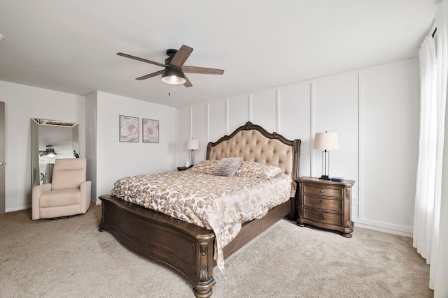 bedroom with a ceiling fan and light carpet