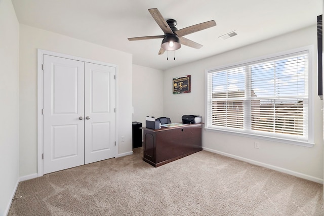 carpeted office featuring ceiling fan, visible vents, and baseboards