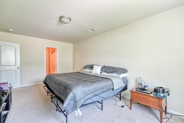 carpeted bedroom featuring visible vents and baseboards