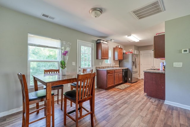 interior space with light wood-type flooring, baseboards, and visible vents