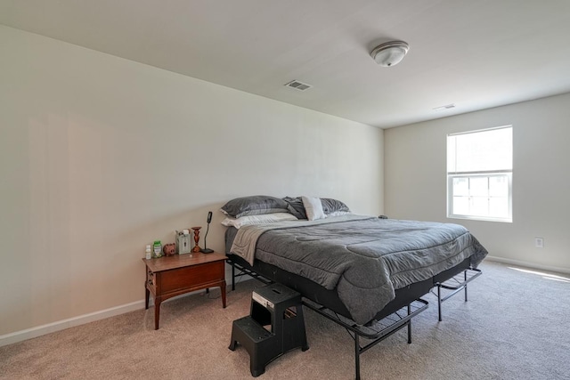 bedroom with light carpet, baseboards, and visible vents