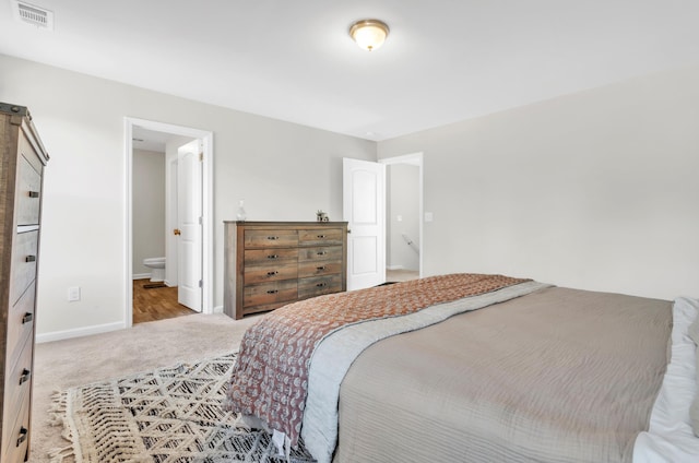 bedroom featuring carpet, visible vents, connected bathroom, and baseboards