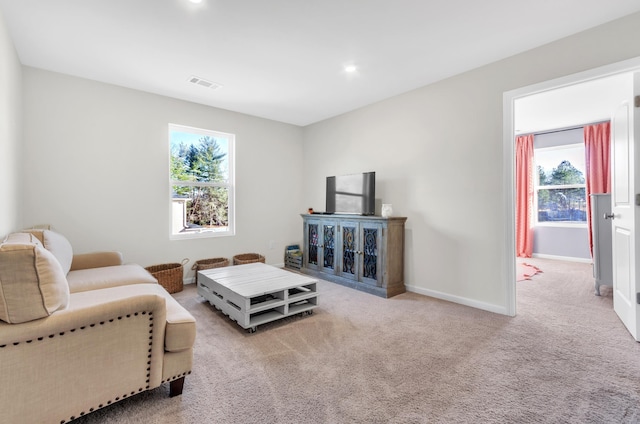 living room featuring baseboards, visible vents, and carpet flooring