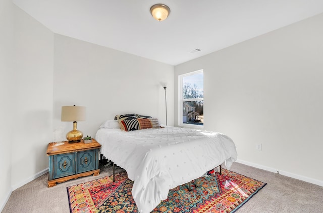 carpeted bedroom with visible vents and baseboards