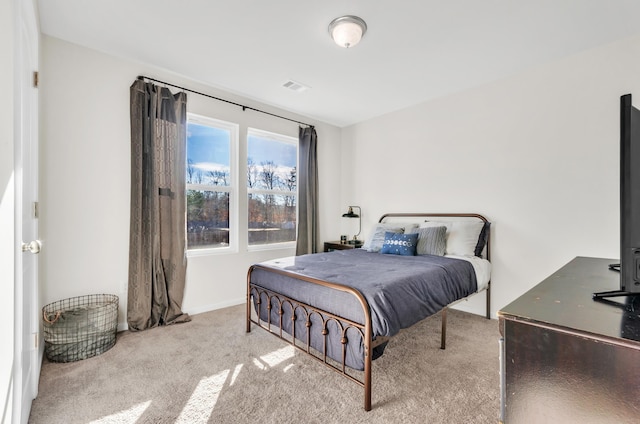 bedroom with carpet, visible vents, and baseboards