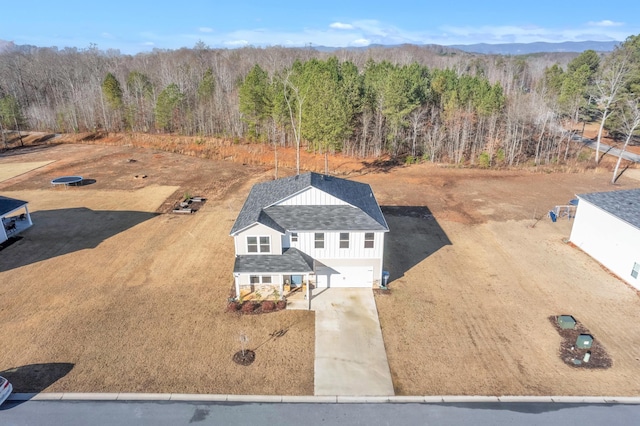 bird's eye view with a wooded view and a mountain view