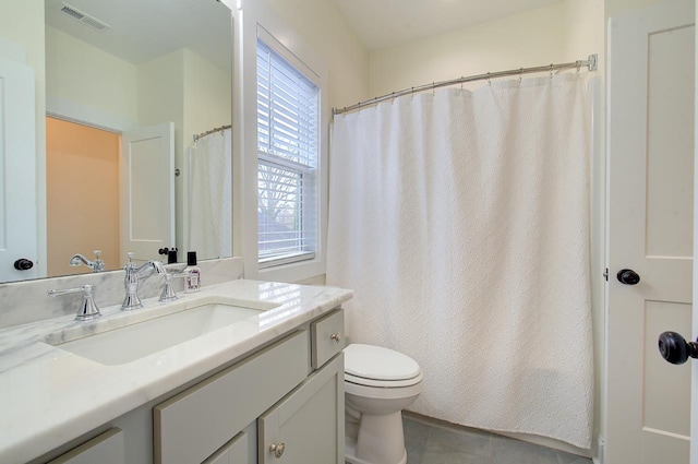 bathroom featuring visible vents, vanity, toilet, and tile patterned floors