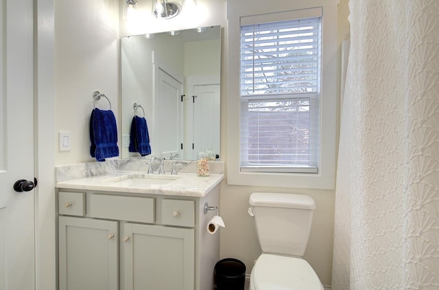 full bathroom featuring vanity and toilet